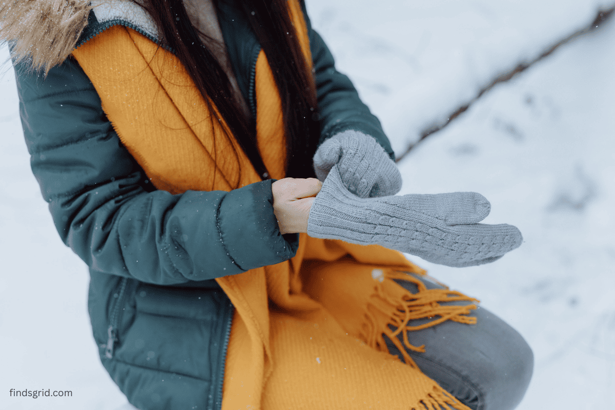 Layering thin gloves under mittens for winter warmth