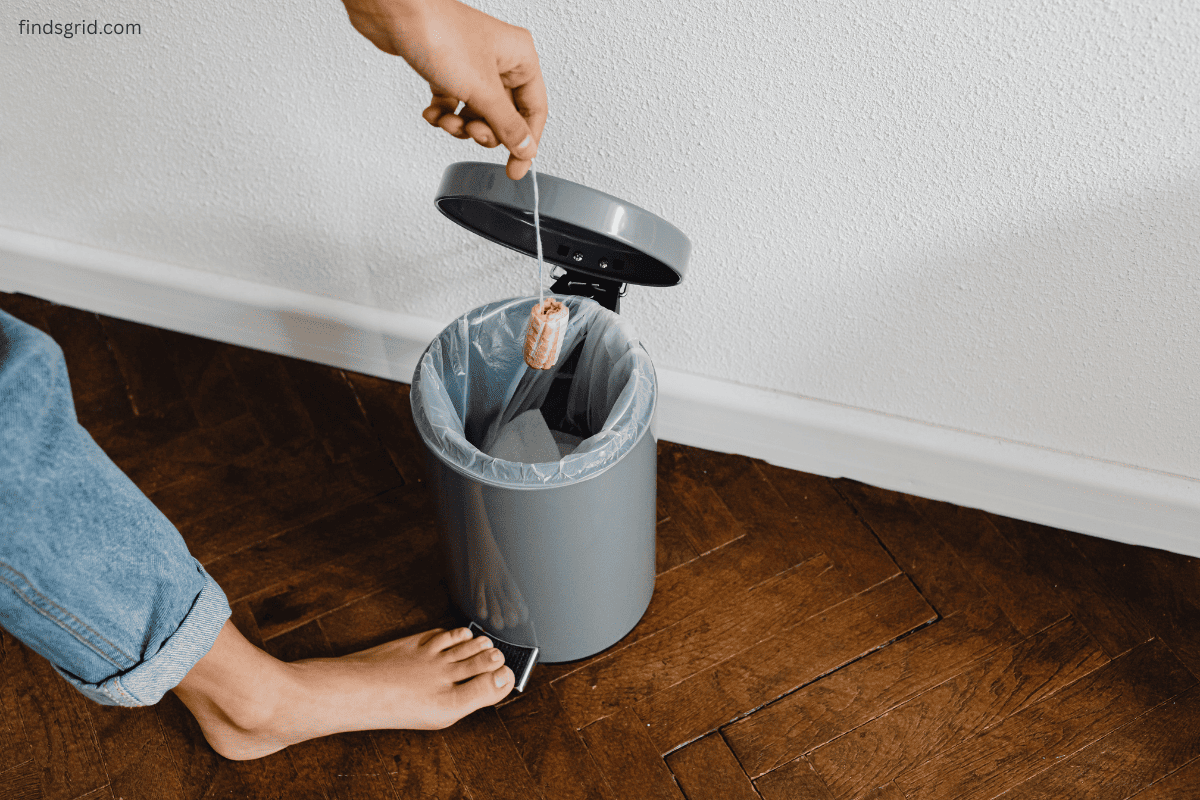 foot pedal trash can in narrow bathroom corner