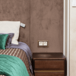 Dorm room bedside charging station setup with floating shelf and outlet extender