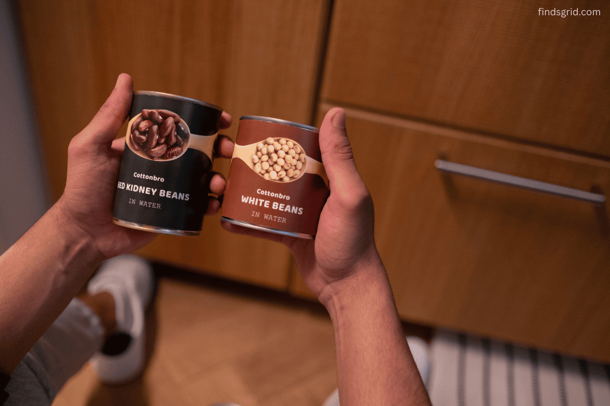 canned soup and beans lined up on a kitchen counter ready to open