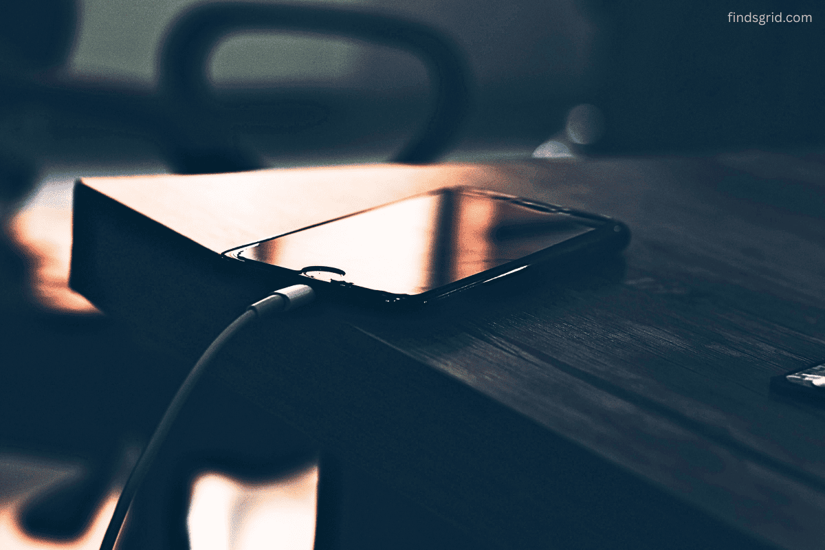 Phone and water bottle placed on small bedside shelf