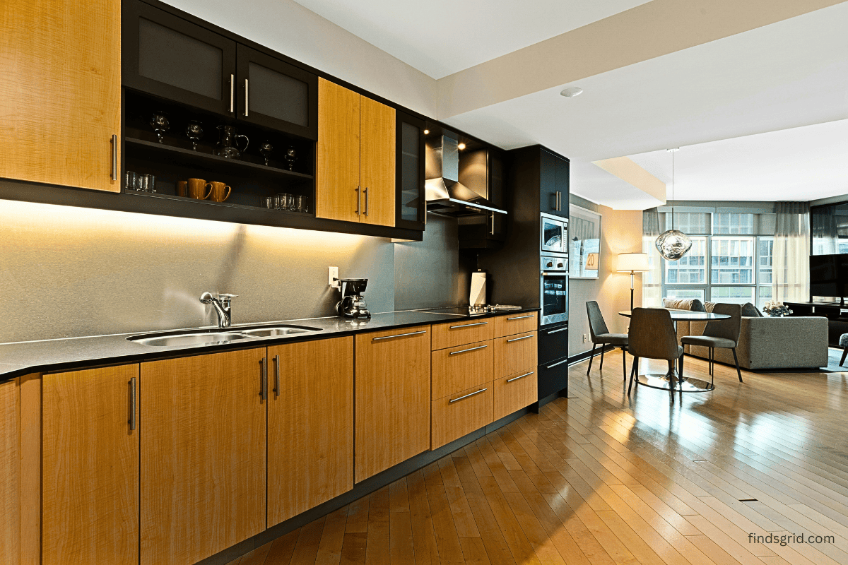 clutter-free kitchen counter with wall cabinets above in a small apartment