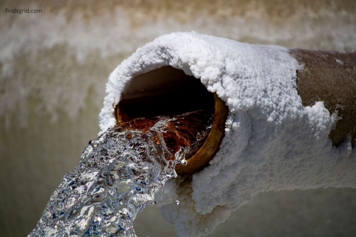 Close-up of a frozen water pipe covered in ice
