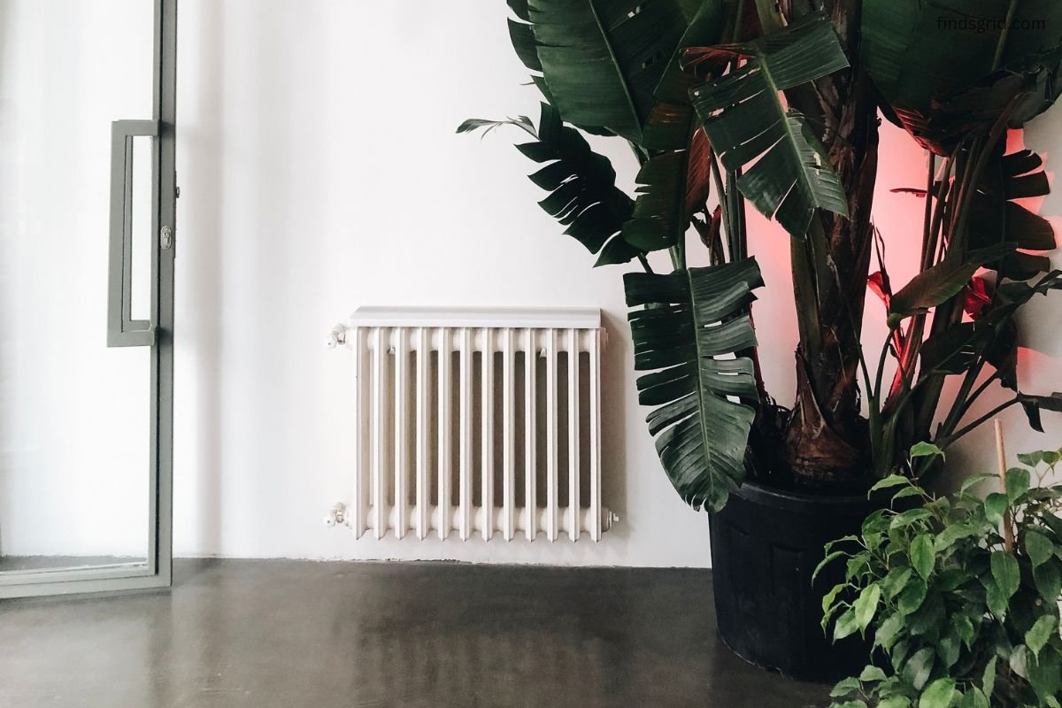 White radiator mounted on an exterior wall in a home