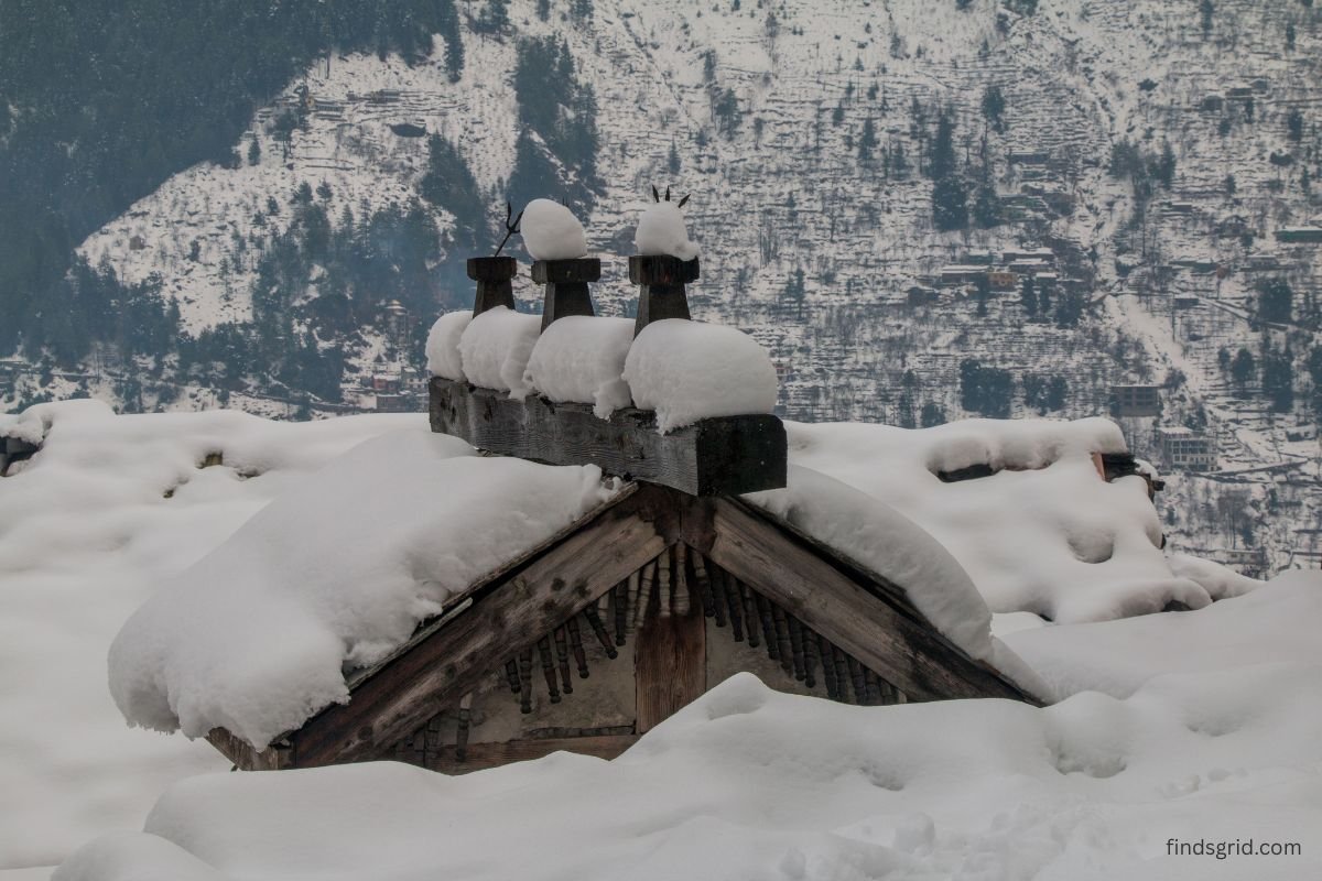 Snow-covered house with a chimney on a cold winter day