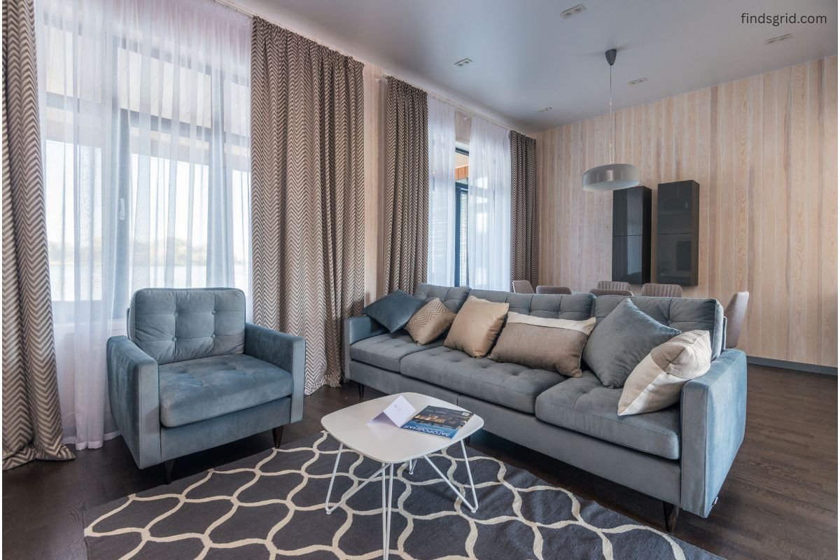 Heavy floor-length thermal curtains covering a window to block cold air