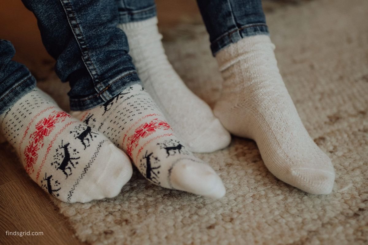 Feet in warm wool socks resting on a thick area rug over a cold floor