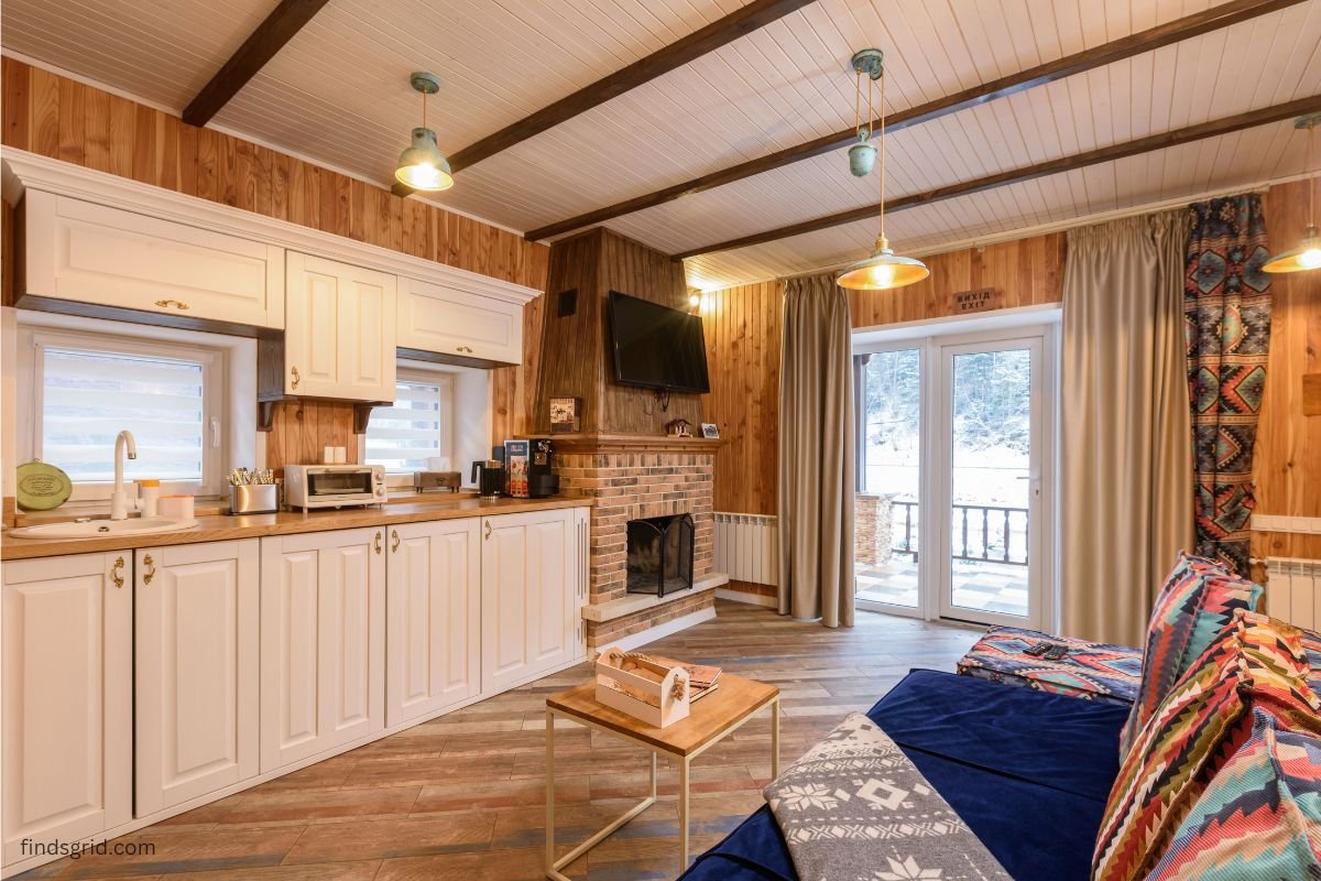 Cozy living room with a warm blanket and snowy window showing winter home heating hacks